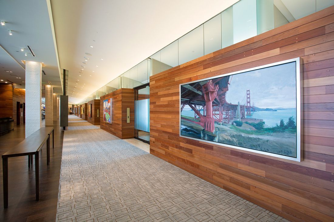 Hallway with wooden walls, art, and a view of the Golden Gate Bridge.