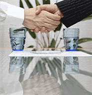 Man and woman shaking hands over signed insurance—Outstanding Glass Services in Danvers, Massachusetts