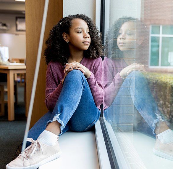 Young Girl Looking Outside The Window — Thousand Oaks, CA — Living Oaks Middle School Academic Alliance Inc