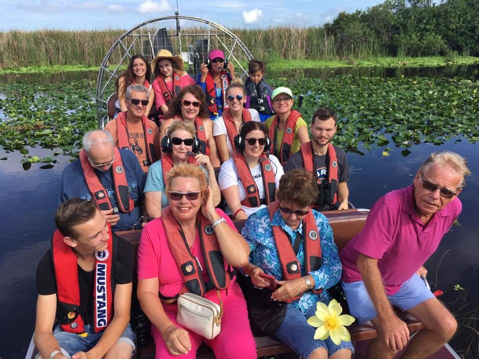 Group of people in an airboat in a swamp