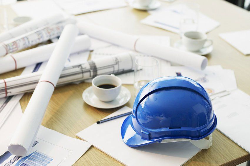 Table with hard-hat and blueprints