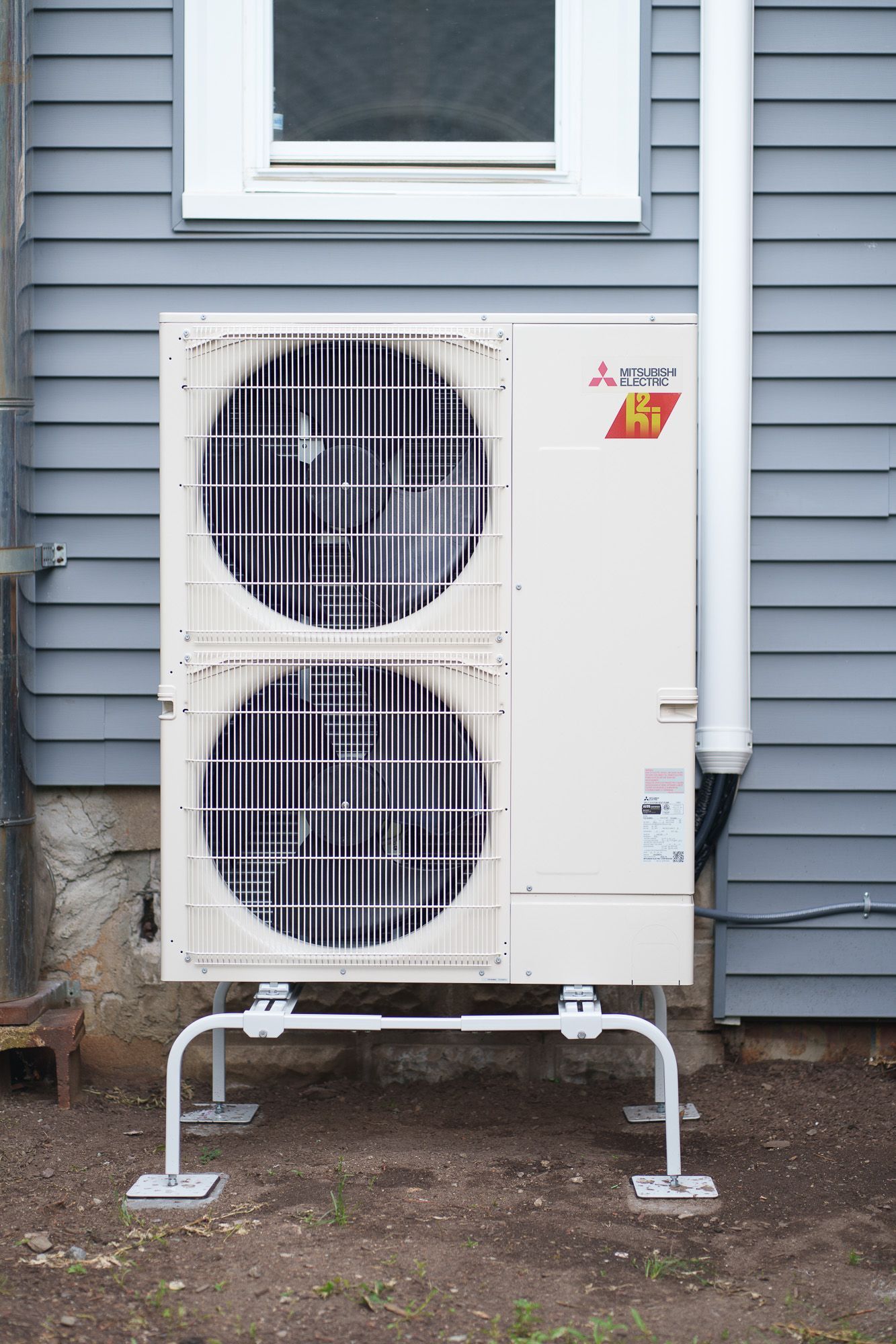 Prevett Heating and Cooling |A Mitsubishi air conditioner is sitting on the side of a house.