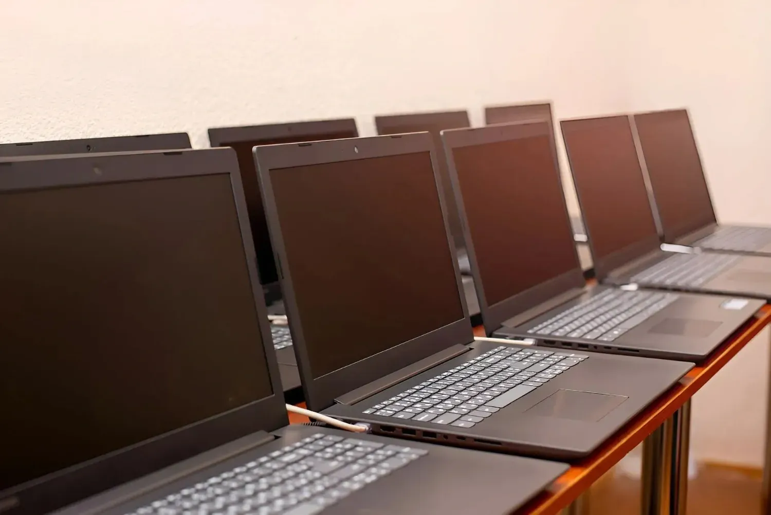 Row of Laptops with Black Screens on A Table — Oz Data Tech in Taree, NSW