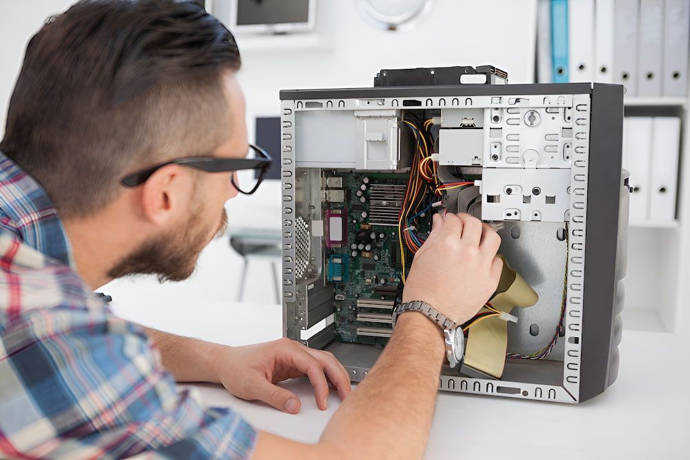 A Man Is Working On The Inside Of A Computer β Oz Data Tech in Forster, NSW