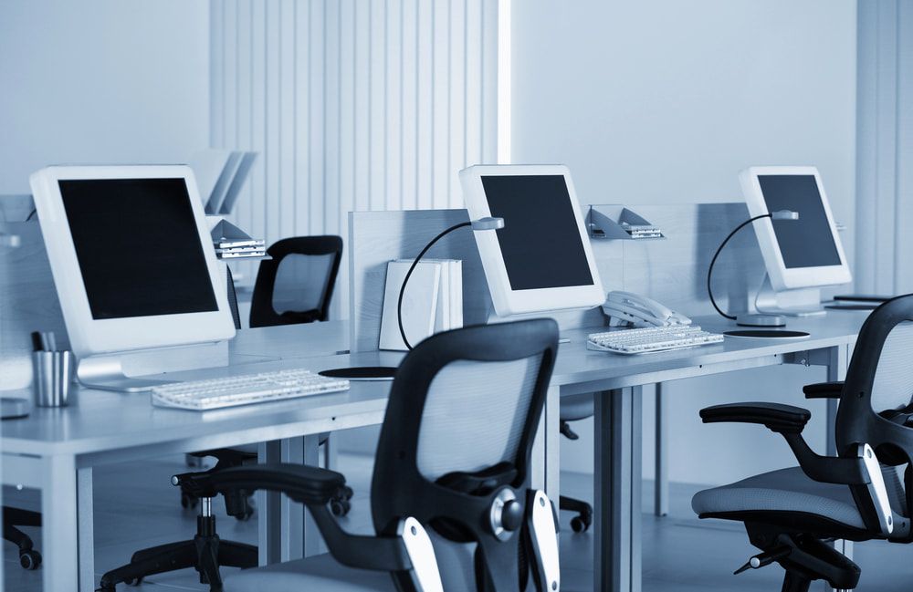 A Row Of Desks With Computers And Chairs In An Office — Oz Data Tech in Forster, NSW