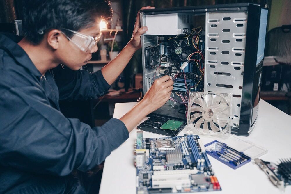 A Man Wearing Safety Glasses Is Working On A Computer β Oz Data Tech in Forster, NSW