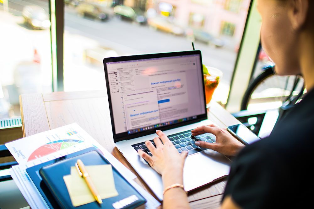 A Woman Is Typing On A Laptop Computer At A Desk β Oz Data Tech in Forster, NSW