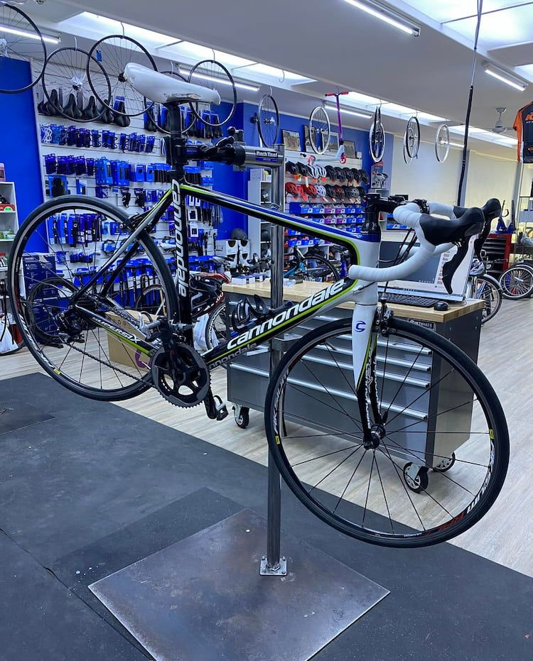 Cannondale road bike on a repair stand in a bike shop — Grafton City Cycles in Grafton, NSW