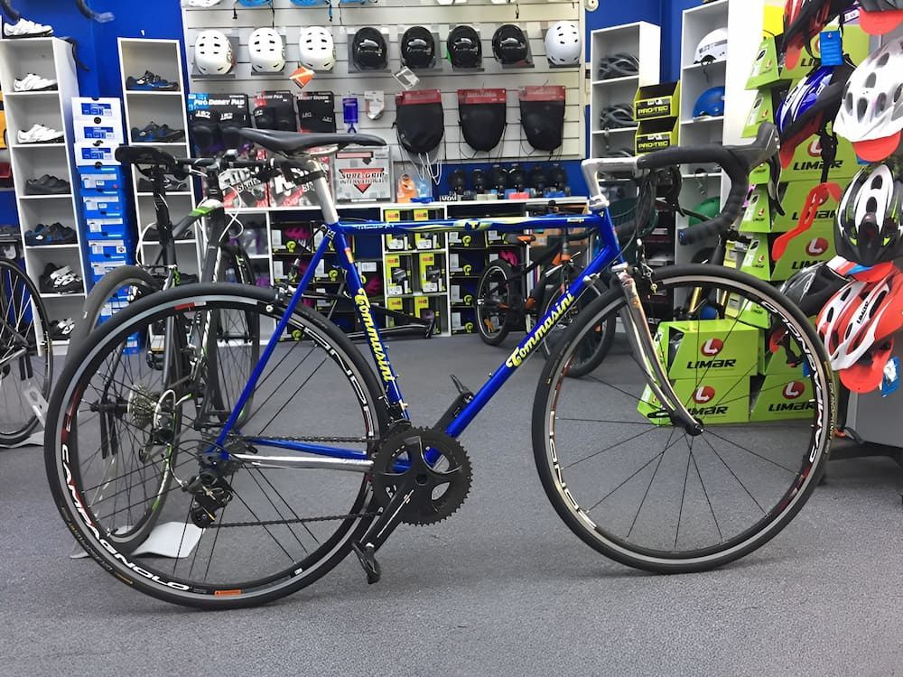 Blue road bike in a bike shop, black tires, silver components — Grafton City Cycles in Grafton, NSW