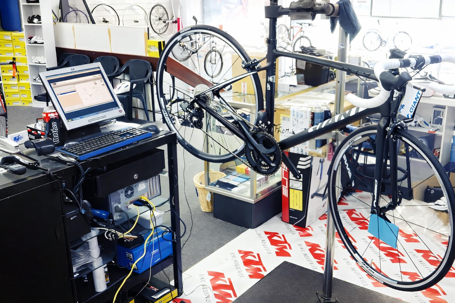 Bicycle being repaired in a shop, with a computer monitor displaying data — Grafton City Cycles in Grafton, NSW