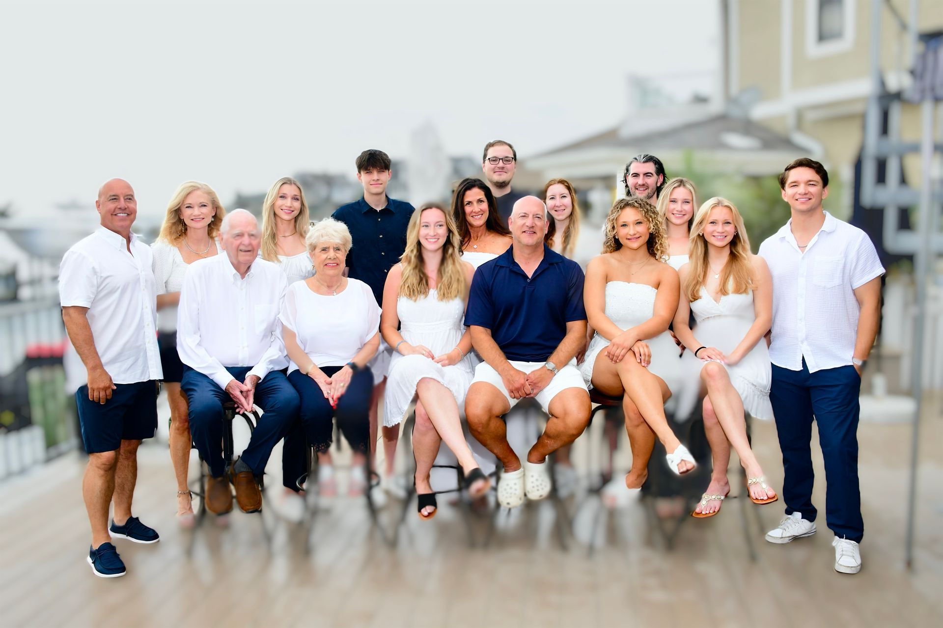 Modern kitchen with gray cabinets, marble countertops, stainless steel appliances, and silver pendant lights.