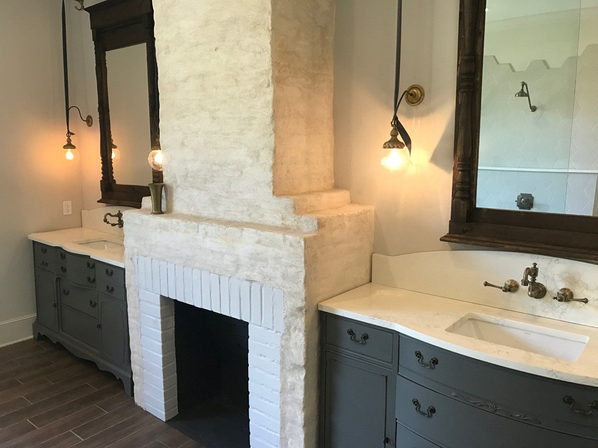 A bathroom with two sinks and a fireplace | Request plumbing service