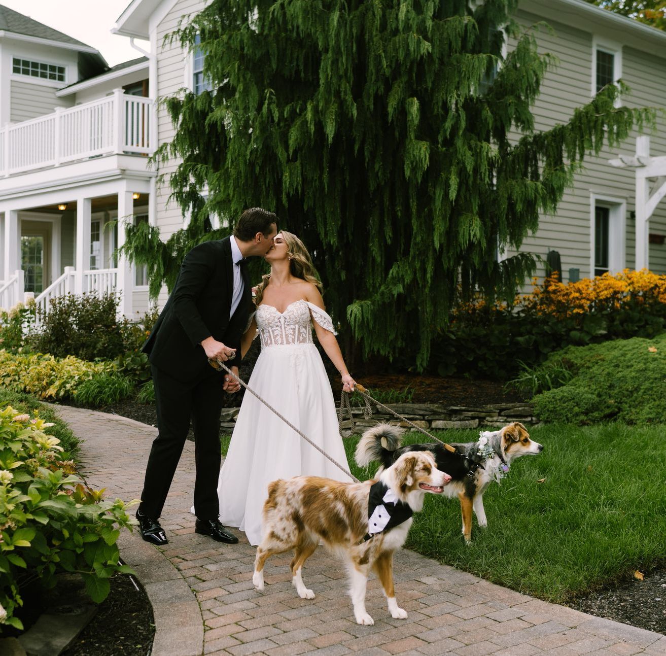 A bride in a wedding dress is holding a bouquet of white flowers.
