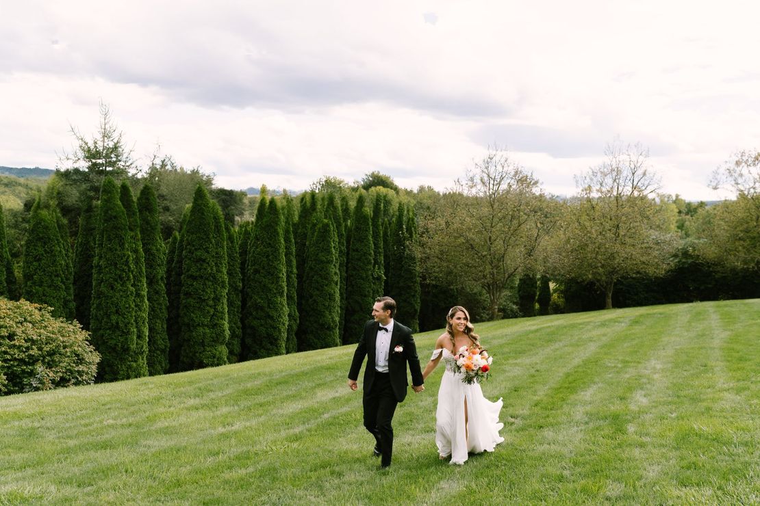 The bride is wearing a white wedding dress and holding a bouquet of flowers.
