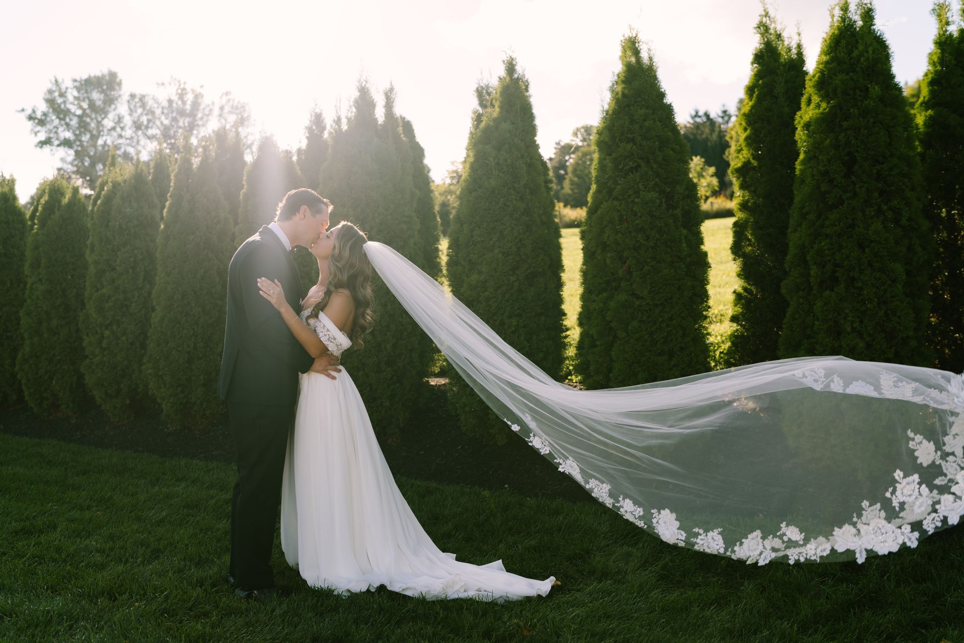 A woman in a white wedding dress is standing in a bridal shop.