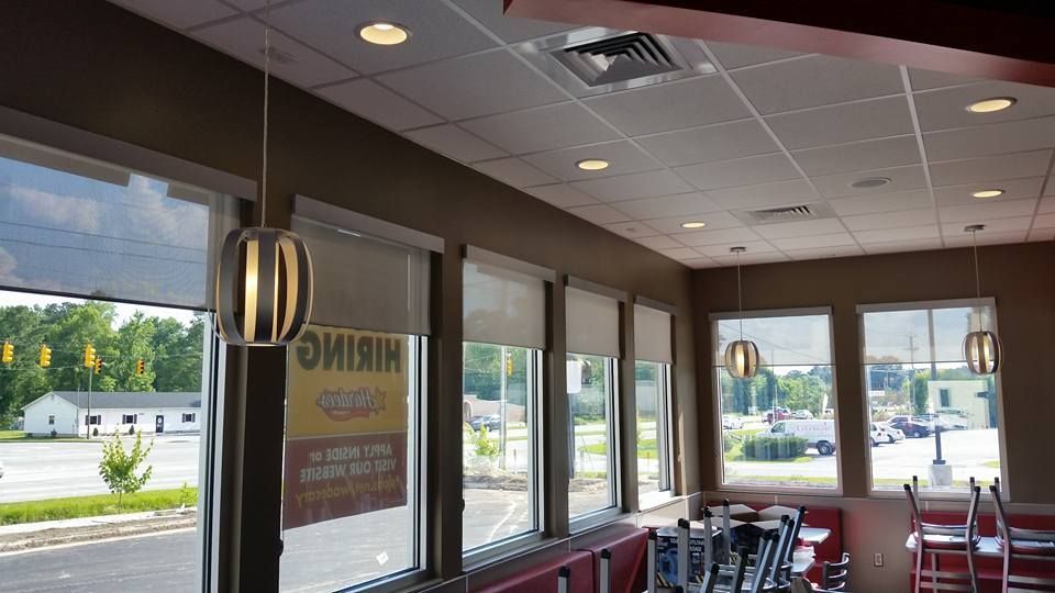 A restaurant with a lot of windows and tables and chairs