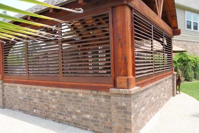 A wooden structure with shutters on the side of it