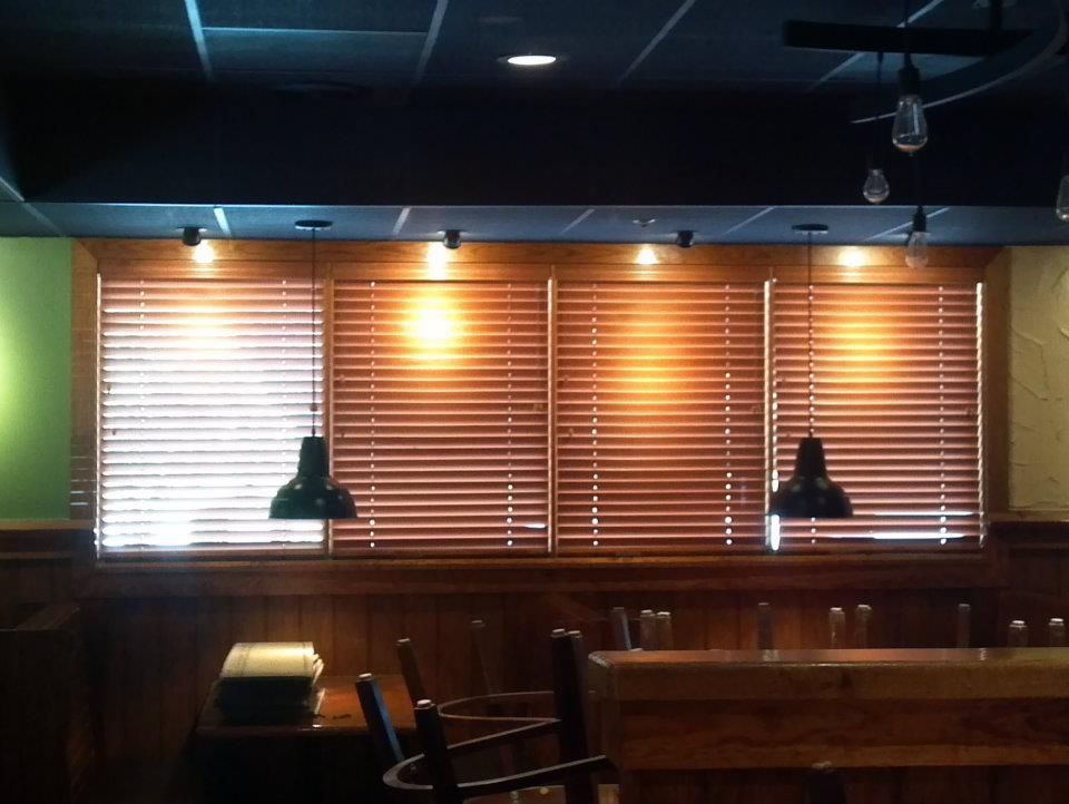 A restaurant with wooden blinds on the windows