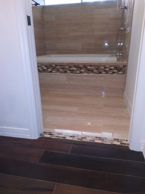 A bathroom with a bathtub and a walk in shower.