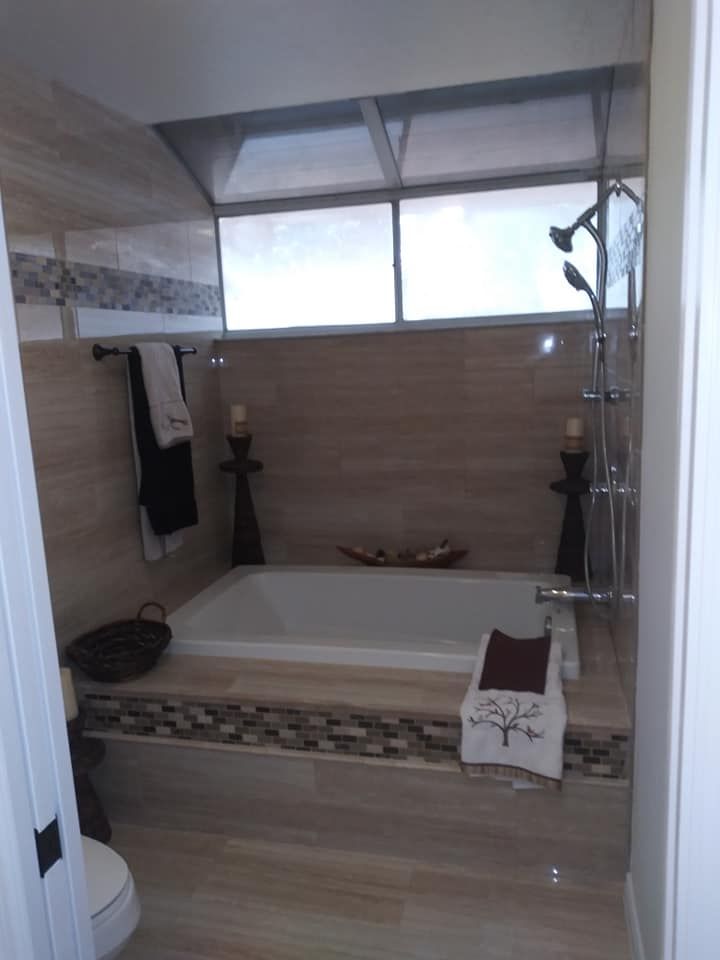 A bathroom with a bathtub and a toilet