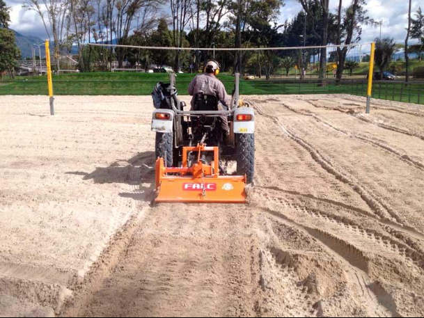 Construction machine leveling ground and preparing the base for a new sport court during a court installation service in Chandler, AZ