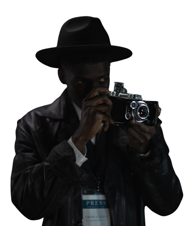 A man in a hat is taking a picture with a camera