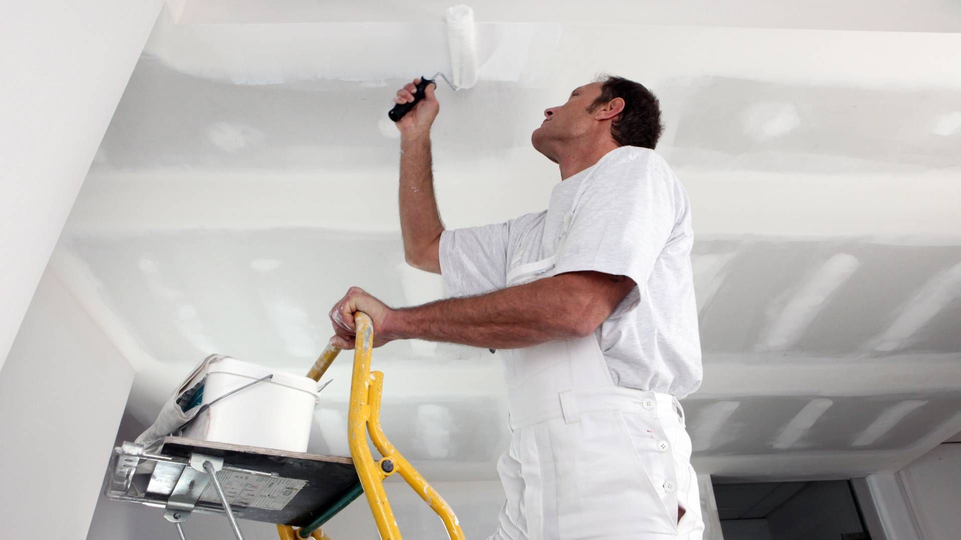 Someone painting a ceiling after they finish painting walls at All About Painting near Johnson City,