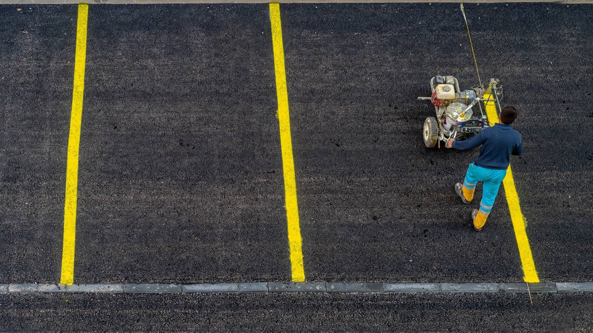 Worker painting a commercial parking lot near Johnson City, TN