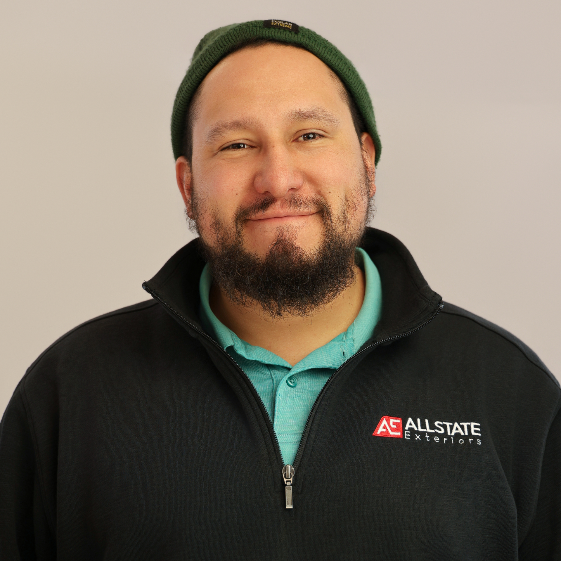 A man with a beard is wearing a hat and sunglasses.