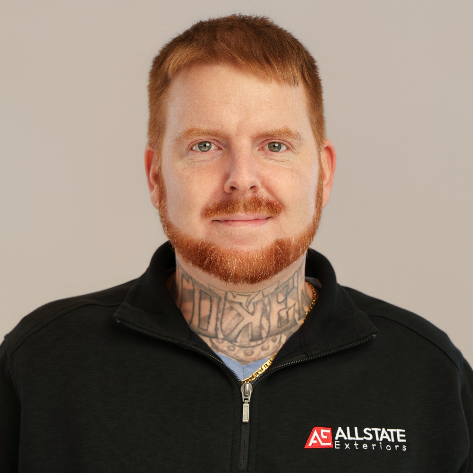 A man with a tattoo on his face is wearing a black shirt.