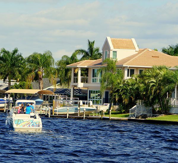 A waterfront home with a boat on the water in Cape Coral, Florida