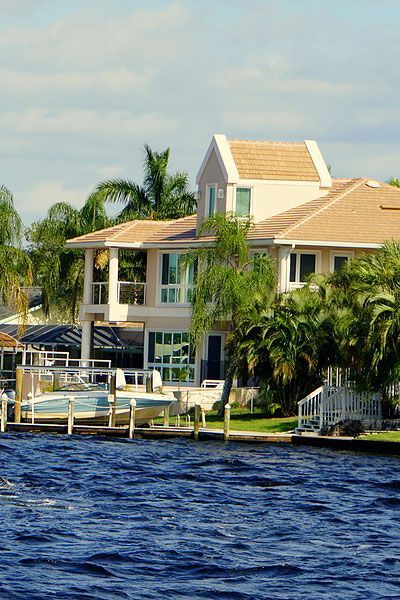 A waterfront home with a boat on the water in Cape Coral, Florida