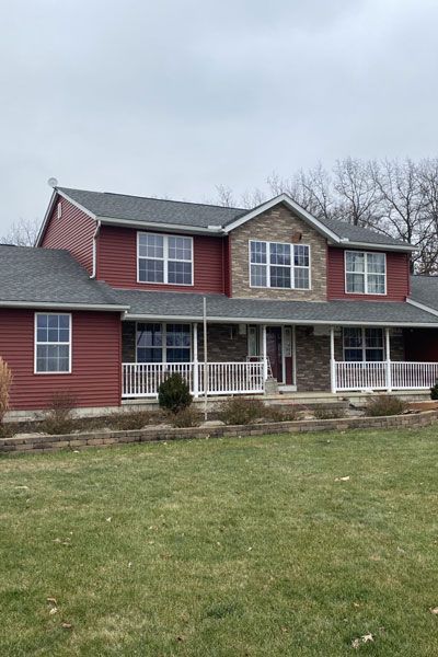 Red farmhouse exterior in Columbus, OH, finished by Allstate Exteriors
