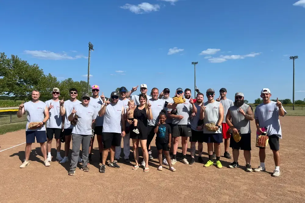 A white house with a black asphalt shingle roof and a window