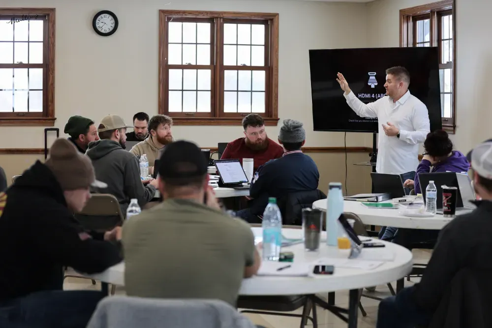 A group of people are working on the roof of a building