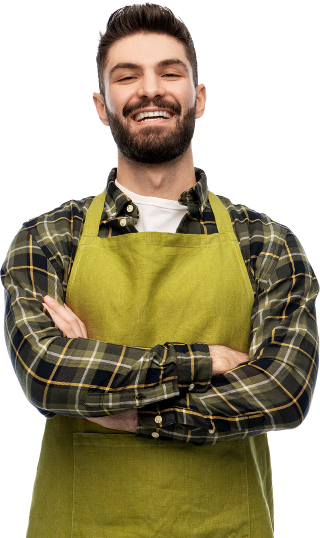Smiling chef in a green apron and plaid shirt with arms crossed on a white background
