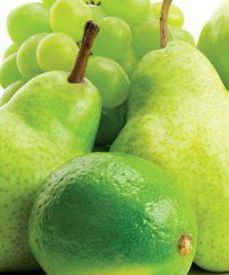 Cluster of green pears and a lime, close-up on a white background