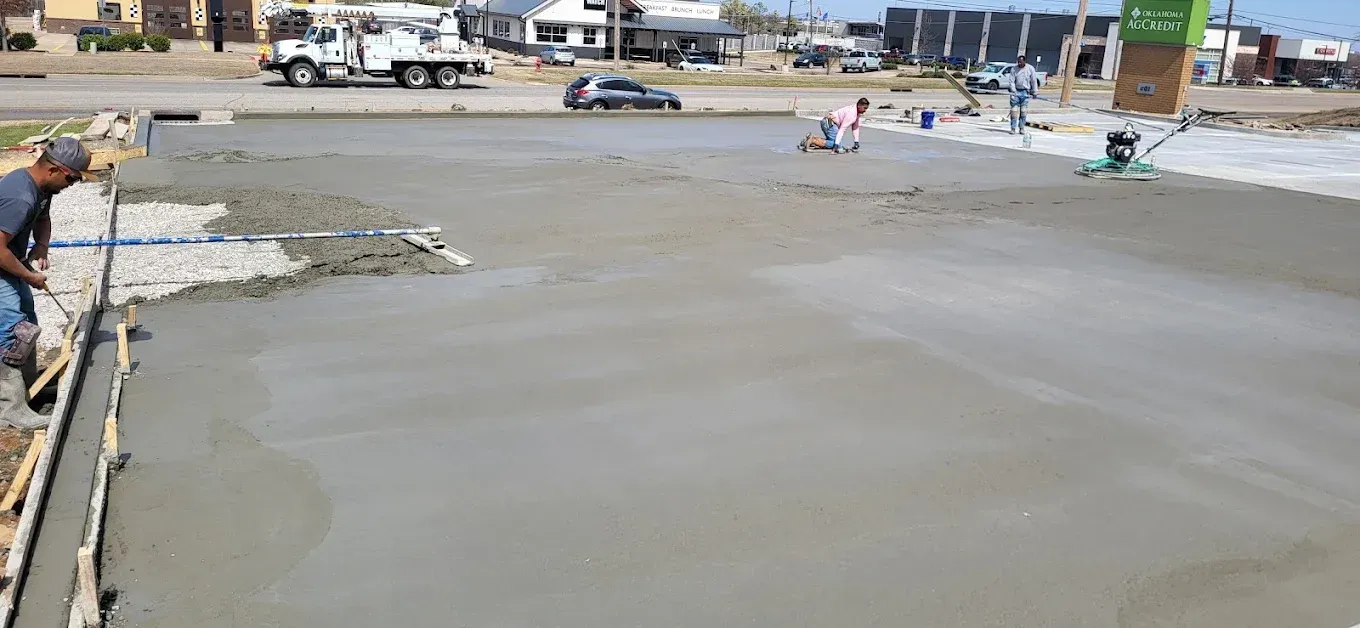 Black and white photograph of a tall building exterior, patterned with vertical columns of windows and textured concrete.