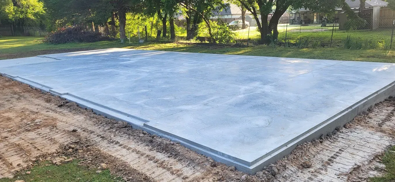 Stacked gray interlocking concrete pavers.
