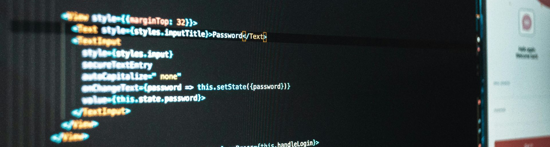 Code on a computer screen, likely HTML, with a black background.