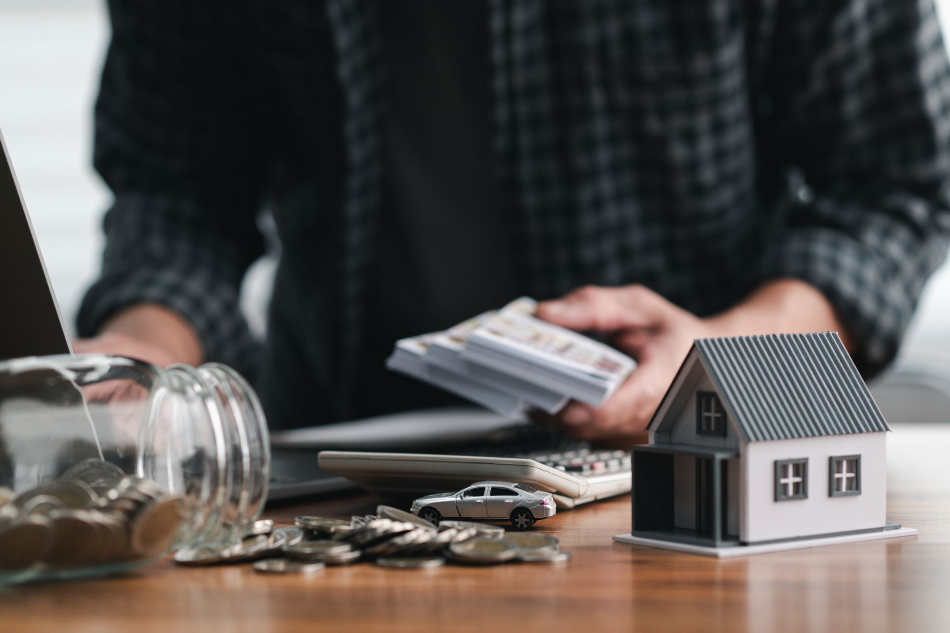 Man counting cash and coins, showcasing escrow account management for smart financial planning.