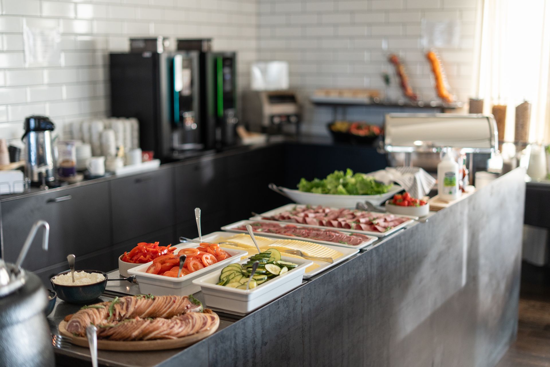 A buffet table with a variety of food on it in a kitchen.