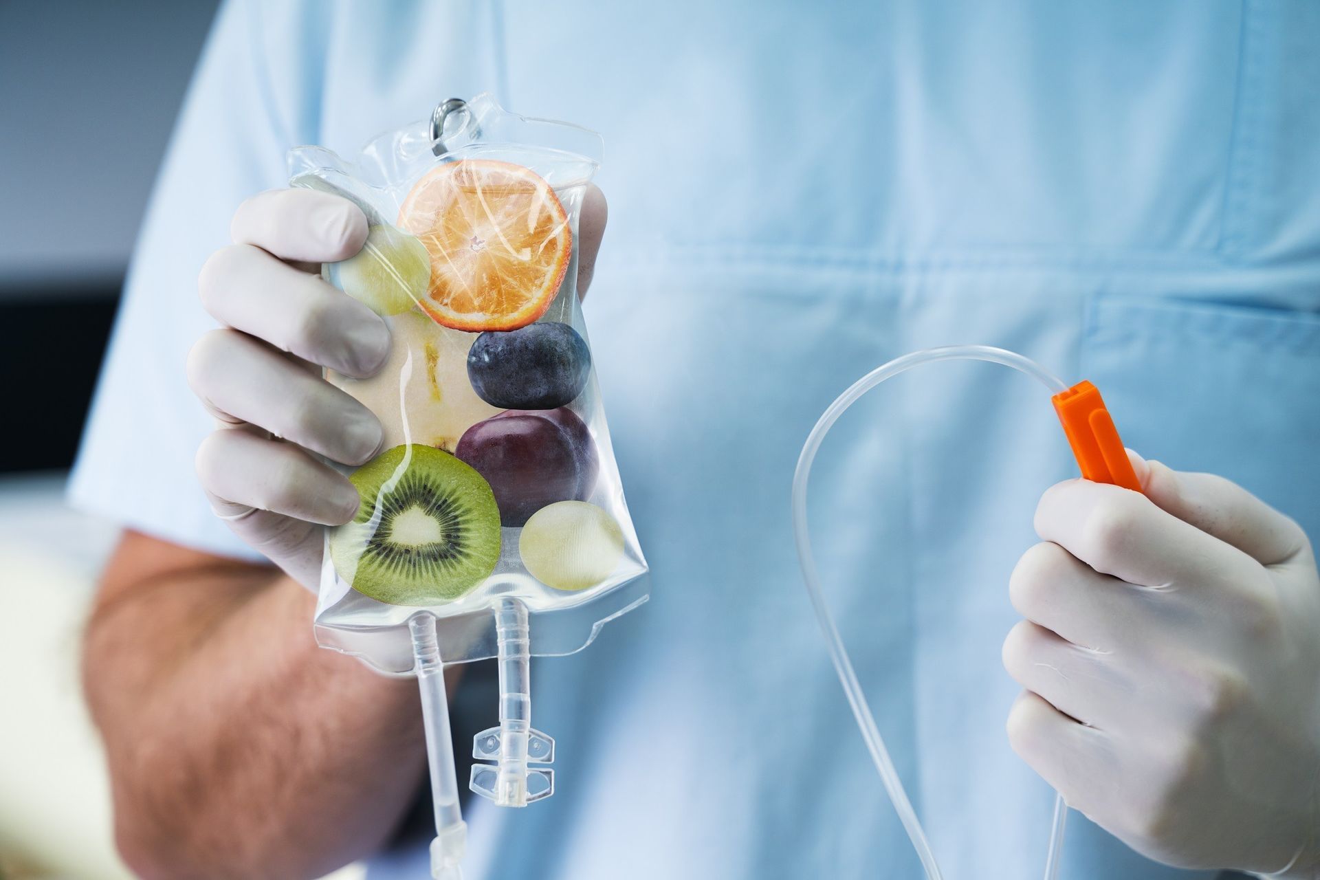 Nurse holding IV bag with fruit slices.