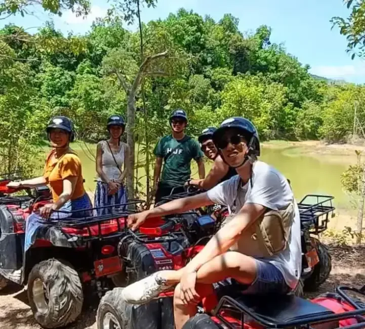 a group of friends riding atv on khlong son