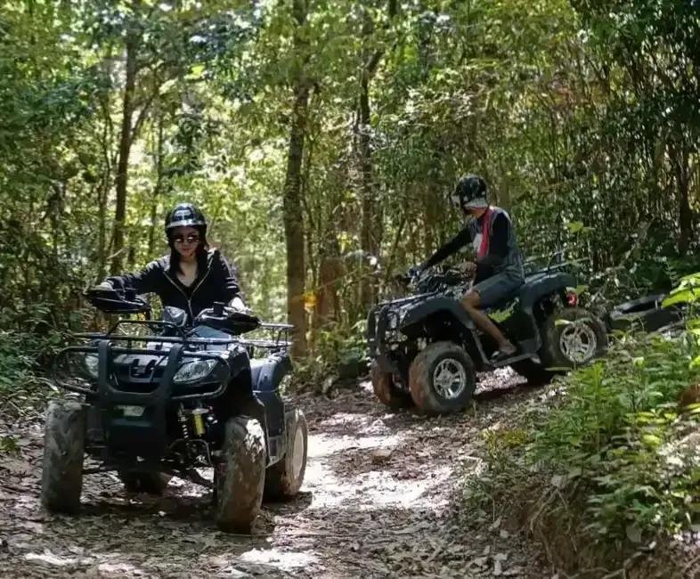 2 people riding atv in khlong son