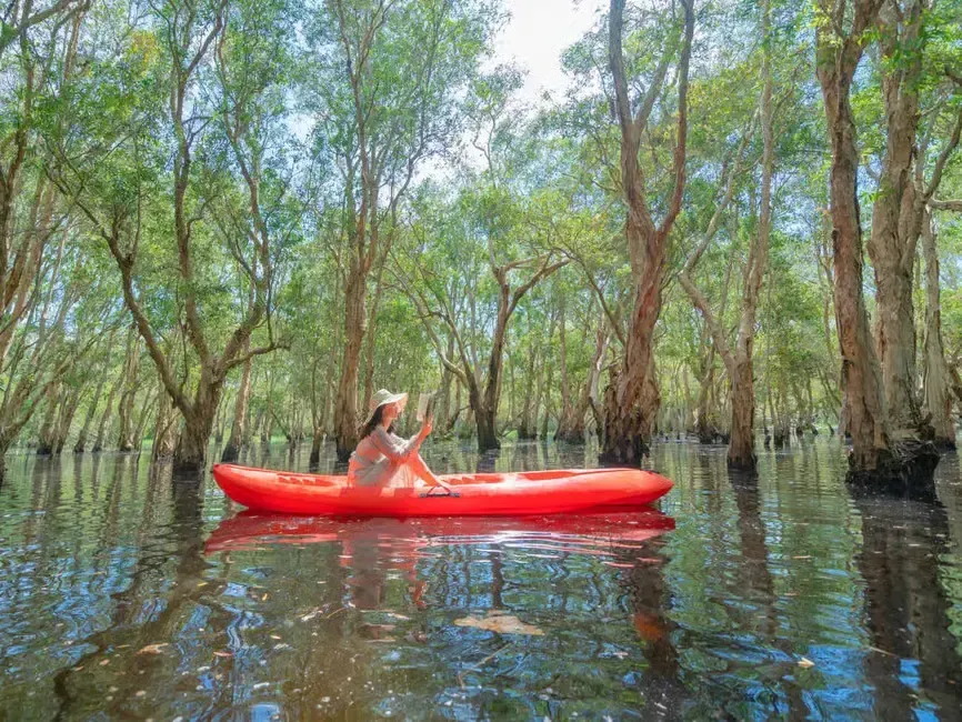 a woman reading a book in kayak