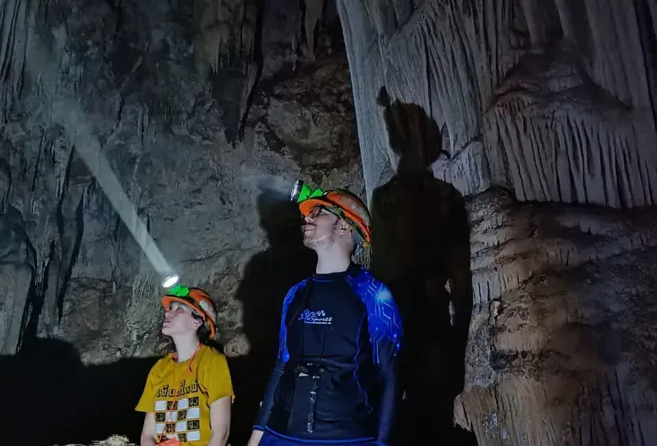 2 person with headlight inside klang cave