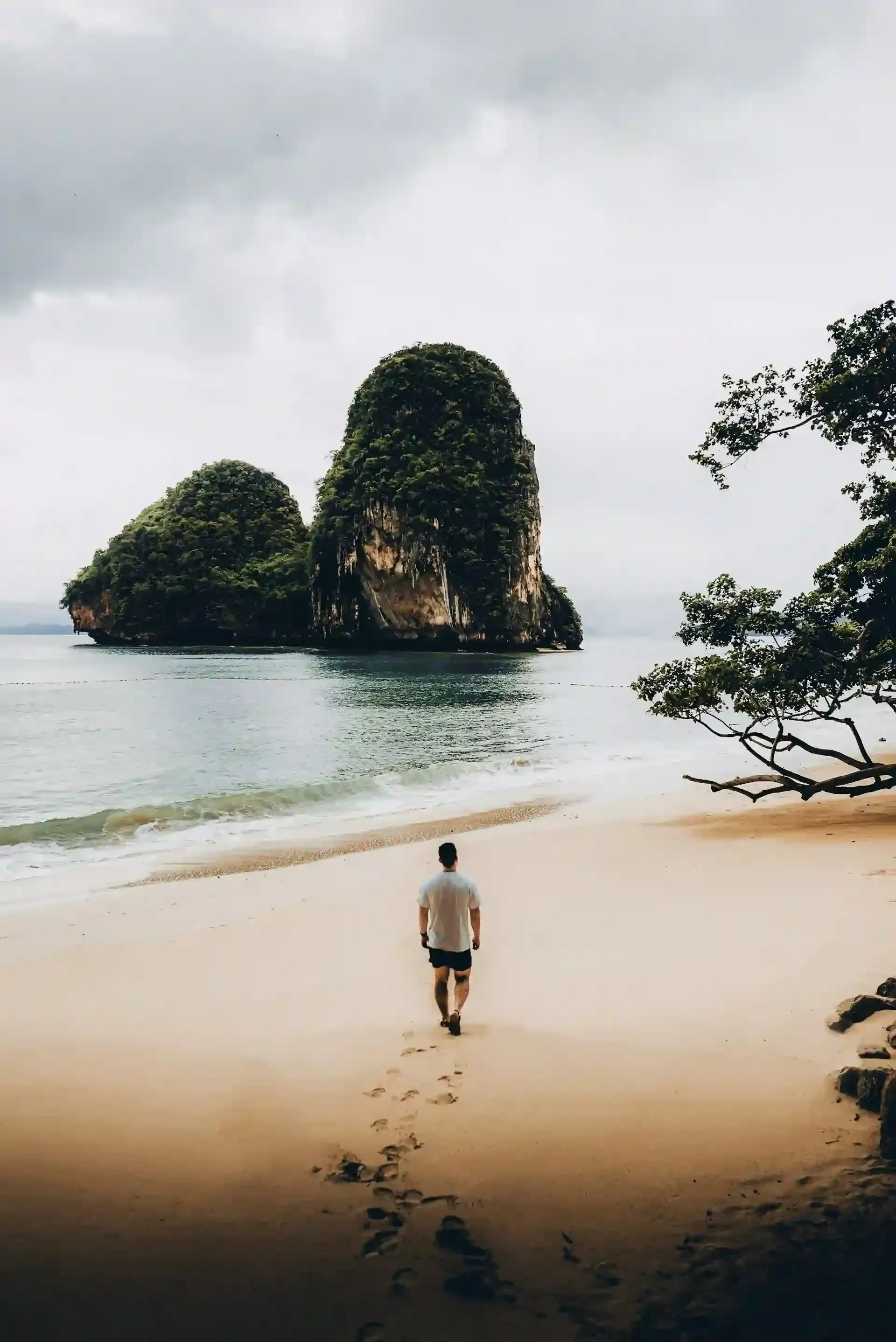 a man standing on railay beach