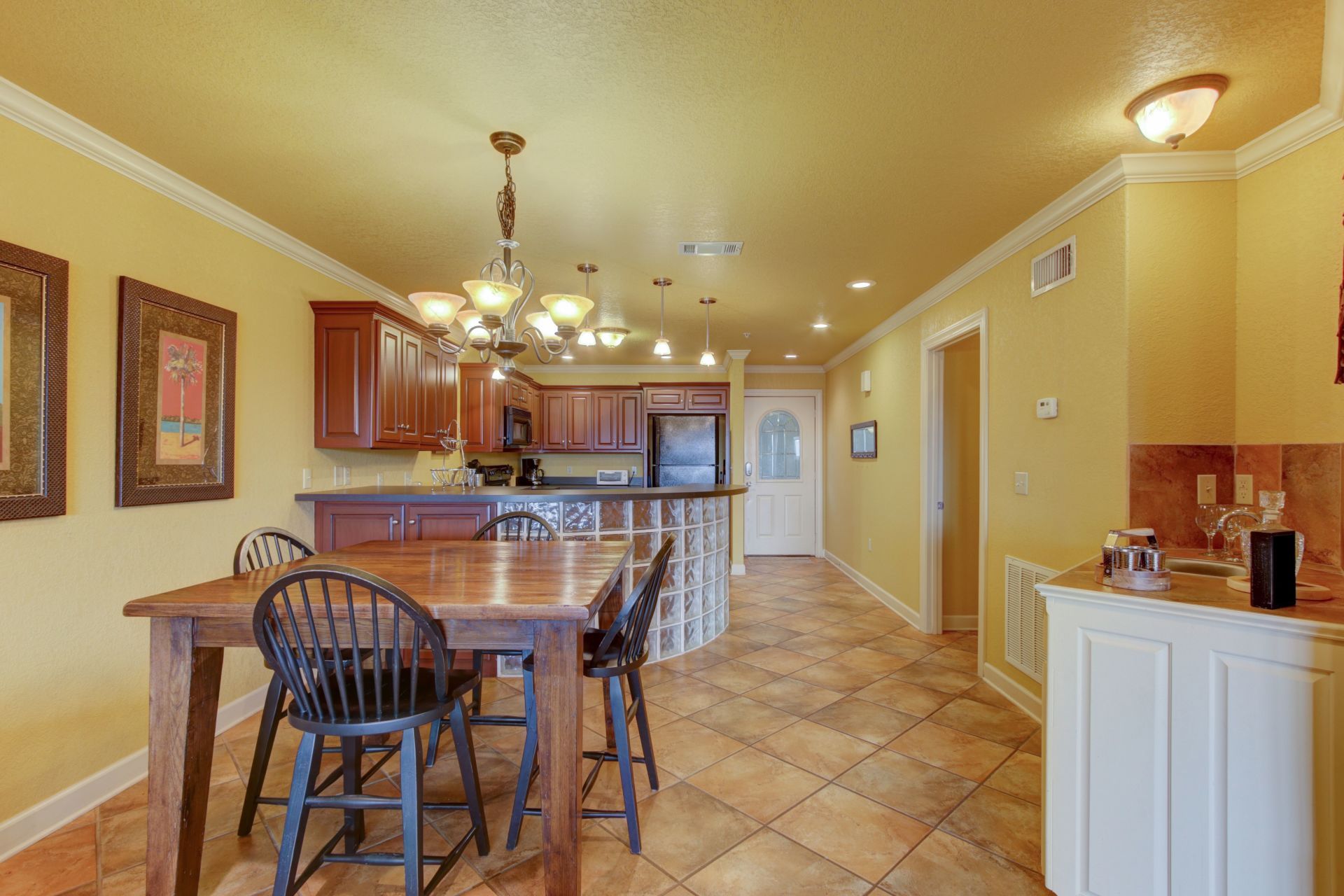 A kitchen with a table and chairs in it