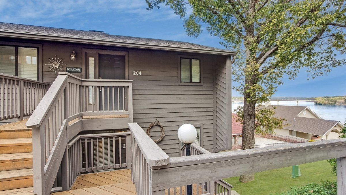 A house with a deck and stairs leading up to it.